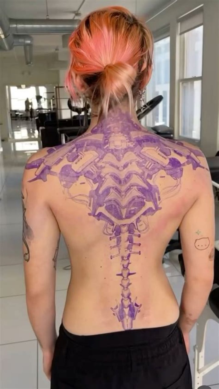 Grimes Reveals Snippets of New Back Tattoo on TikTok - Insights into the Singer’s Various Tattoos